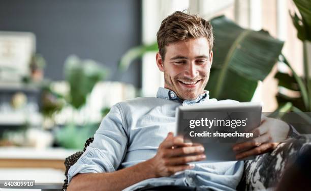 access to the world in the palm of his hand - tablet stockfoto's en -beelden