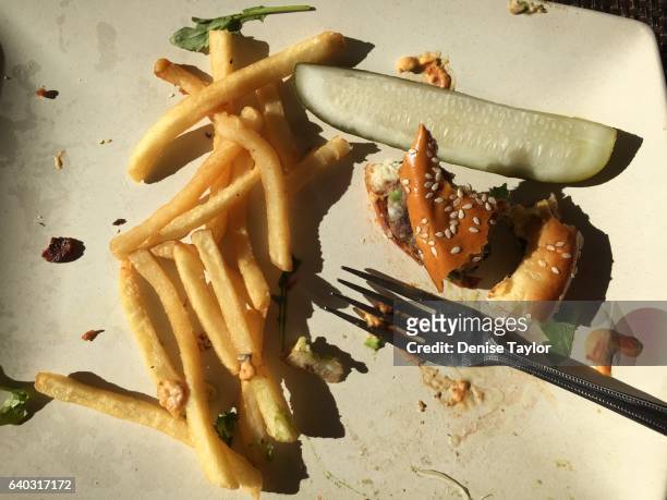 leftover food on plate - leftover stockfoto's en -beelden