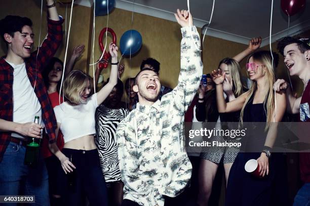 group of friends having fun at a party - party of five stockfoto's en -beelden