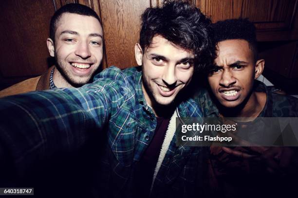 group of friends taking selfies at a party - all men group selfie stock pictures, royalty-free photos & images