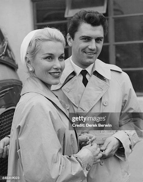 British actor Edmund Purdom with actress Linda Christian , the ex-wife of screen idol Tyrone Power, at London Airport, UK, 9th August 1956. The...