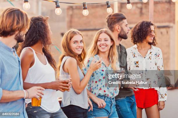 happy friends at the rooftop party - izabela habur stock pictures, royalty-free photos & images