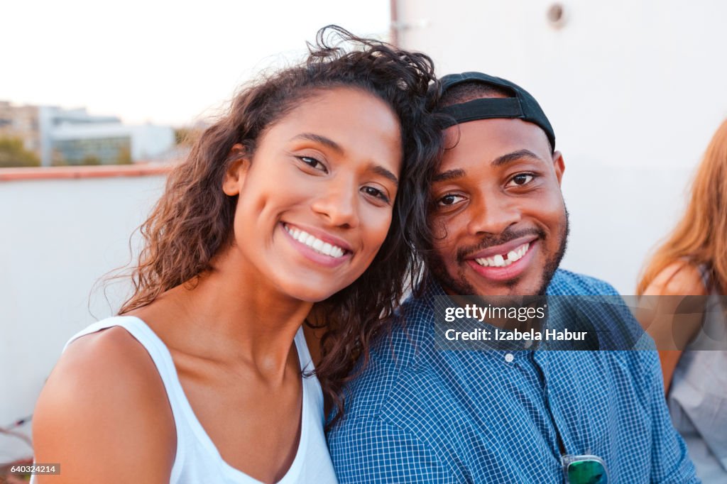 Happy young couple at the rooftop party