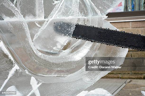 making a ice sculpture with chainsaw - ice sculpture stock pictures, royalty-free photos & images