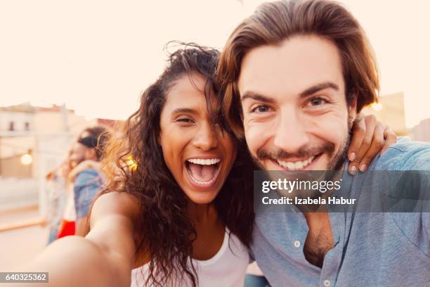 happy young couple at the rooftop party - happy face close up stockfoto's en -beelden