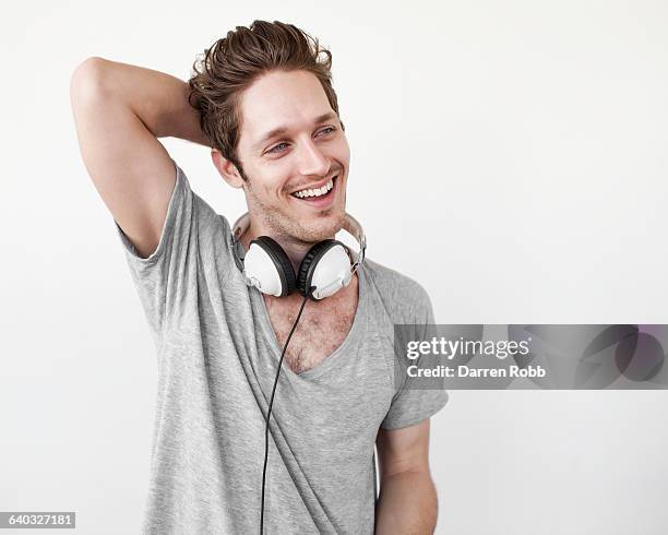 man wearing headphones, smiling - hands behind head stock pictures, royalty-free photos & images