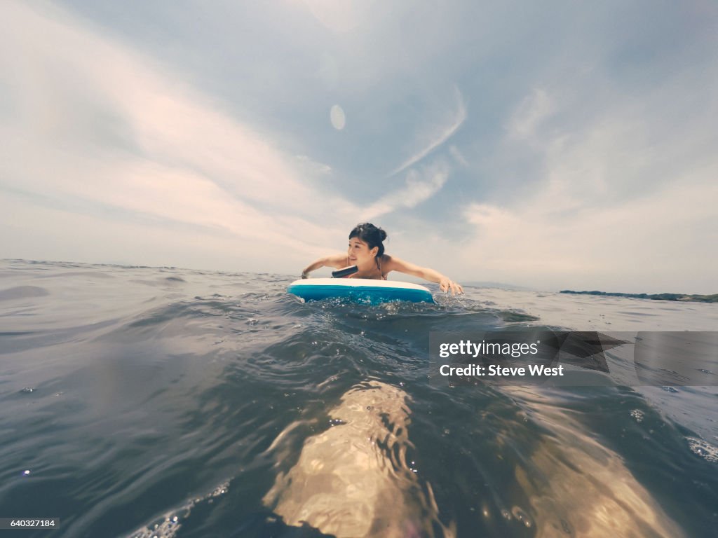 Young Woman A Paddleboard In The Ocean