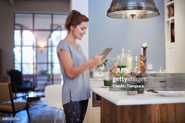 preparing a green smoothie at home. - tablet alcohol stock pictures, royalty-free photos & images