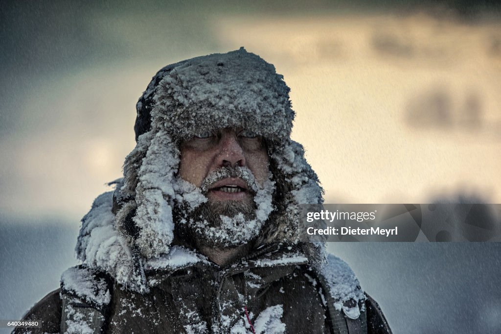Man covered by snow in heavy snowstorm