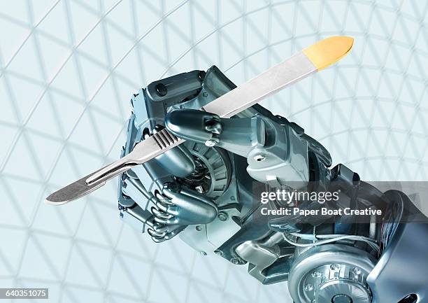 robot hand holding a surgeon's scalpel - cyborg stock-fotos und bilder