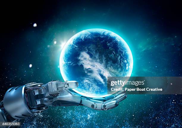 mettalic robot hand holding a glowing globe - world hands stock pictures, royalty-free photos & images