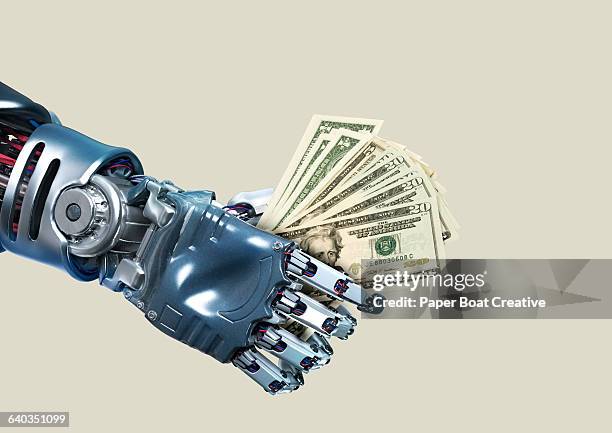 robot hand holding lots of dollar notes - money surreal stock pictures, royalty-free photos & images