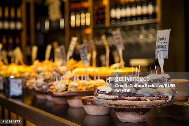 selection of pintxos tapas on restaurant counter. bilbao, spain - tapas spain stock pictures, royalty-free photos & images