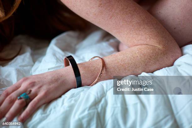 arm of a naked woman with freckled skin and bracelets - semi dress stock pictures, royalty-free photos & images
