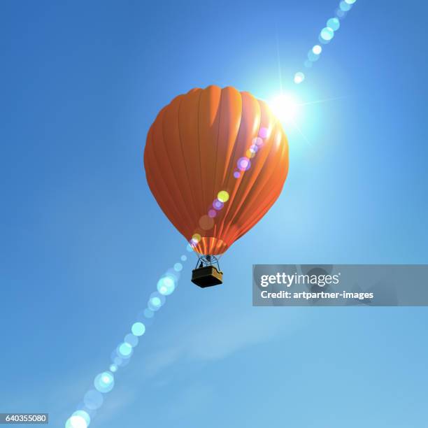 hot air ballon flying in the sky - heissluftballon stock-fotos und bilder