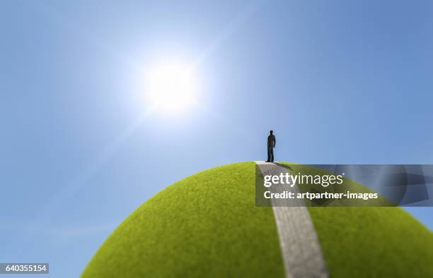 man reaching a mountain top - digital fulfillment stock-fotos und bilder