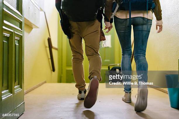 backpackers walking out of apartment - backpacker apartment stock pictures, royalty-free photos & images