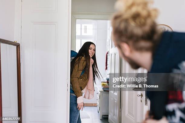 couple leaving apartment with backpacks - cool couple in apartment stock pictures, royalty-free photos & images