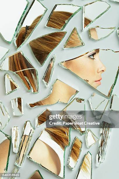 side profile of a young lady in broken mirrors - broken mirror imagens e fotografias de stock