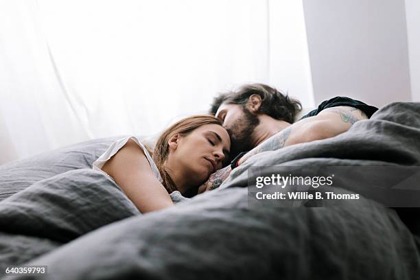 couple sleeping in bed together - bed foto e immagini stock