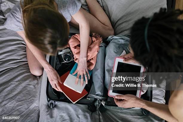 interracial couple packing suitcase - analog technology stock pictures, royalty-free photos & images