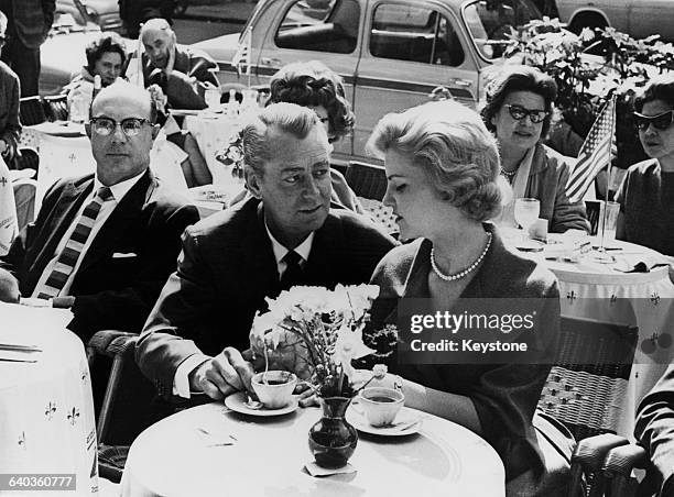 American actor Alan Ladd and his daughter Alana drinking coffee in a cafe on the Via Veneto, Rome, 22nd March 1961. They are both in Italy to star in...