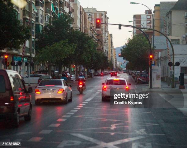 europe, spain, malaga, view of road on rainy day - stoplight fotografías e imágenes de stock