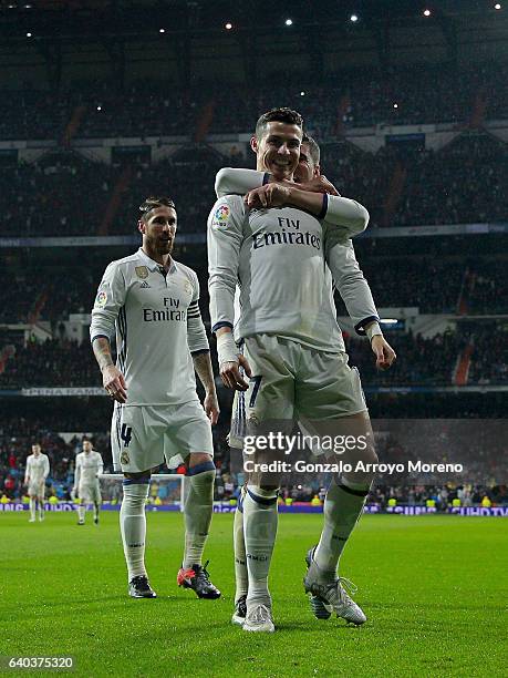 Cristiano Ronaldo celebrates scoring their second goal with teammate Carlos Casemiro and Sergio Ramos during the La Liga match between Real Madrid CF...