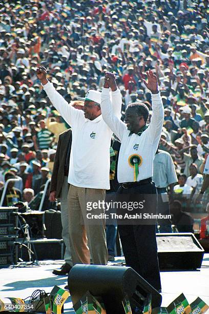 South African President Nelson Mandela and Vice President and ANC presidential candidate Thabo Mbeki applaud the crowd during the election campaign...