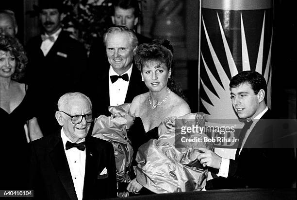 At a formal gala, Sarah, Duchess of York, and her husband, Prince Andrew, Duke of York are joined by American businessmen Armand Hammer and Lodwrick...