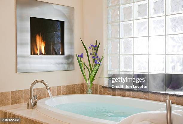 bath with fireplace - running water bath stock pictures, royalty-free photos & images