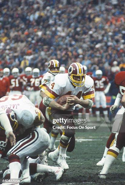 Washington, D.C. Running back John Riggins of the Washington Redskins carries the ball against the St. Louis Cardinals during an NFL football game...