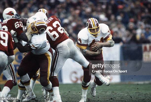 Washington, D.C. Running back John Riggins of the Washington Redskins carries the ball against the St. Louis Cardinals during an NFL football game...