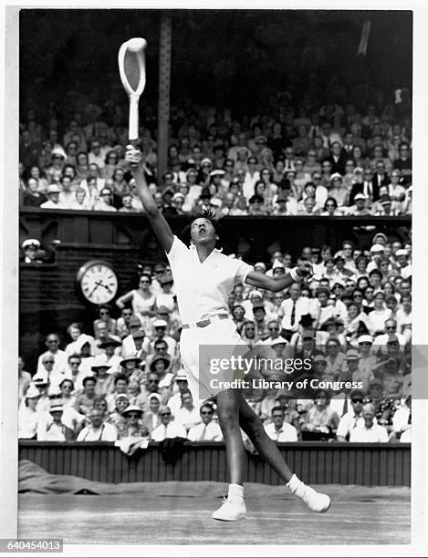 Althea Gibson plays tennis at Wimbeldon.