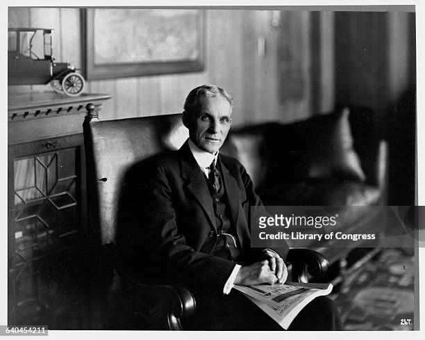 Henry Ford Sitting in Armchair with Magazine