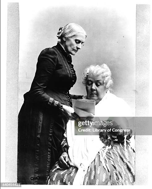 American women's rights pioneers Susan B. Anthony, standing, and Elizabeth Cady Stanton read a letter, circa 1890.