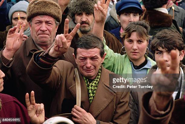 Crowd of emotional Romanians show peace and victory signs after the overthrow of their nation's communist dictator Nicolae Ceausescu.