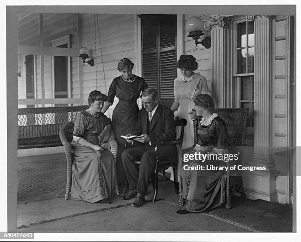 Governor Woodrow Wilson, who was to become the 28th President of the United States, reads to his wife and three daughters.