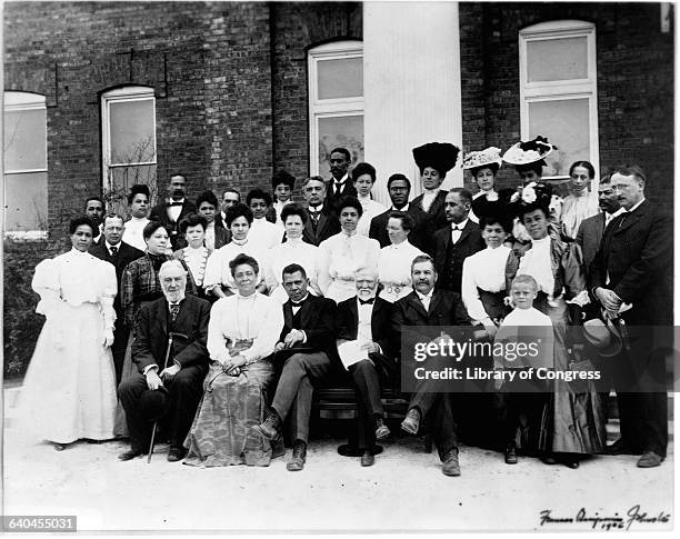 Co-principals Booker T. Washington and his wife Margaret Washington pose with Andrew Carnegie and faculty at the twenty-fifth anniversarty of the...