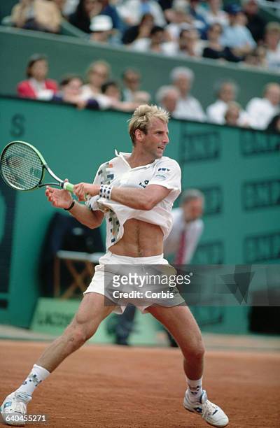 Thomas Muster returns a shot in a tennis match at the French Open.