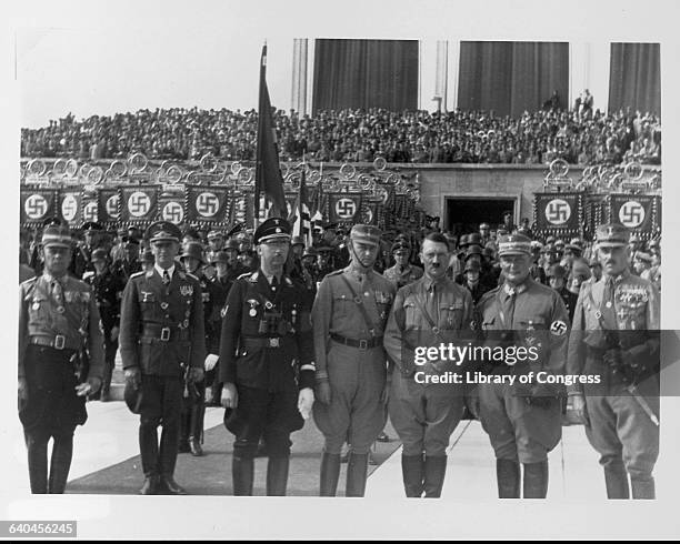 Adolph Hitler, Hermann Goering, and Heinrich Himmler stand with other Nazi leaders at a Party rally in Nuremberg.