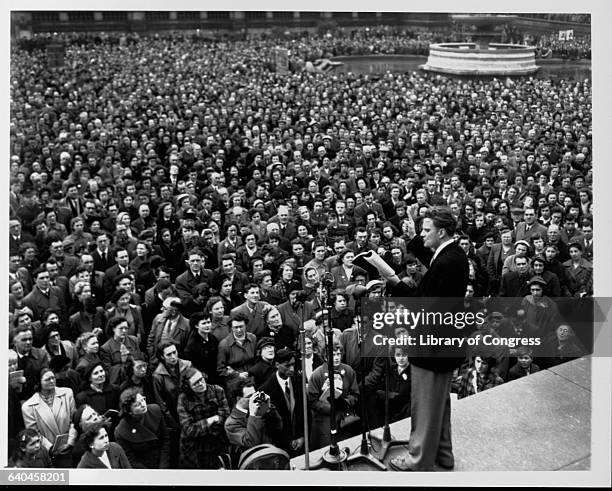 American evangelist Billy Graham preaches to a large crowd in London's Trafalgar Square. April 1954.