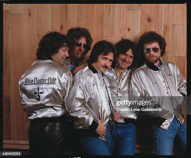 Blue Oyster Cult members pose in matching silver jackets. From left to right: Albert Bouchard, Allen Lanier, Donald "Buck Dharma" Roeser, Joe...