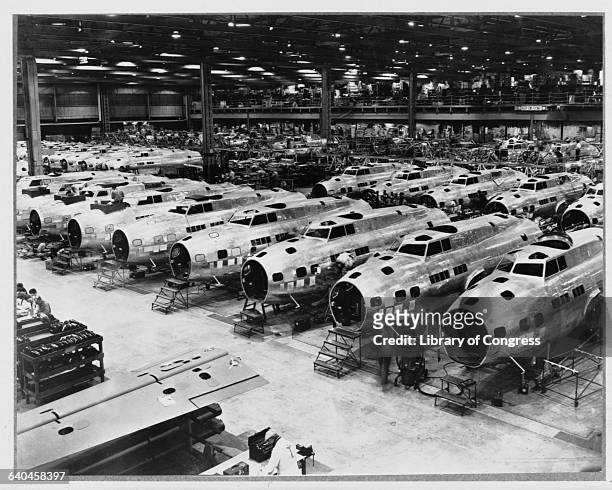Rows of B-17 Flying Fortress heavy bombers are under production at a Boeing plant in Seattle, Washington. 1942-1945.