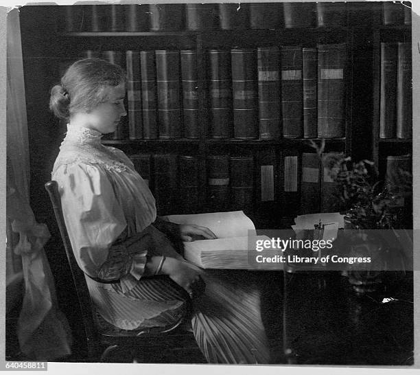 Writer Helen Keller Holding Braille Book in Study