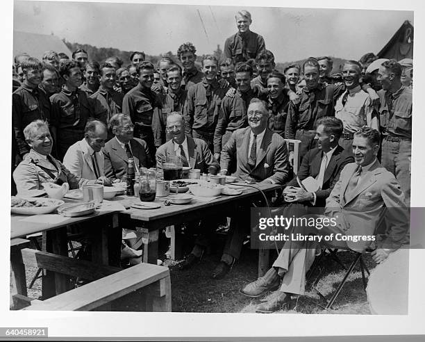 Franklin Roosevelt and other administration officials visit a Civilian Conservation Corps Camp during the New Deal.