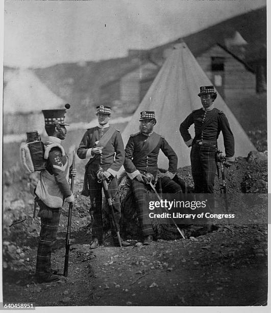 Soldiers of the 71st Regiment stand with a color sergeant in camp during the Crimean War. 1853-1856.