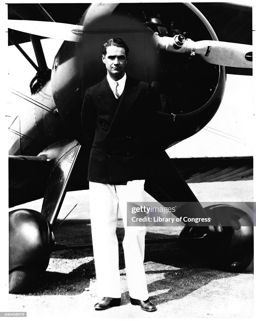 Howard Hughes Standing with Boeing Biplane