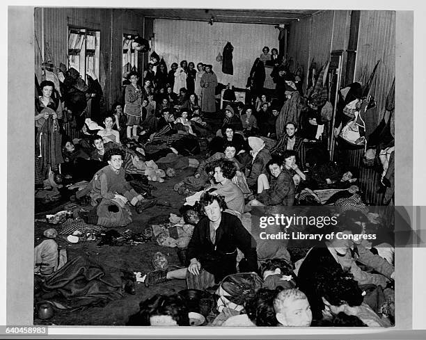 Hundreds of women and children have been packed into one room at the Bergen-Belsen Concentration Camp in Germany. 1943-1945.