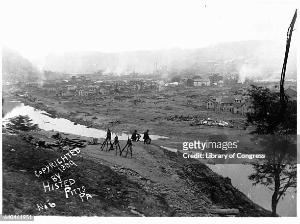 Soldiers sit on a hill overlooking Johnstown, Pennsylvania after the 1889 flood. Over 2,000 people died in the disaster. | Location: Kernville Hill,...